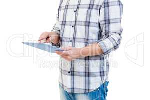 Mid section of man using tablet computer