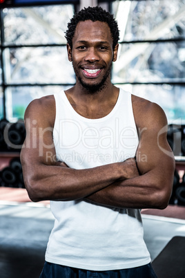 Muscular man posing with crossed arms