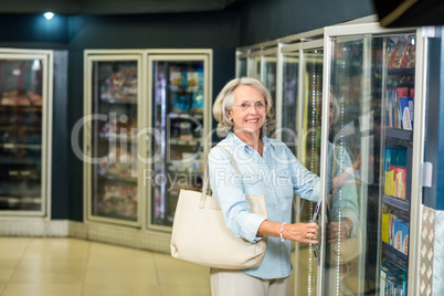 Smiling senior woman buying food