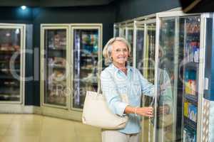 Smiling senior woman buying food