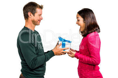 Excited girlfriend taking gift from boyfriend