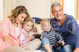 Happy family enjoying video games together