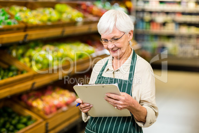 Smiling senior worker with clipboard