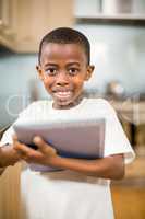 Smiling boy using tablet