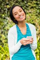 Happy brunette using smartphone