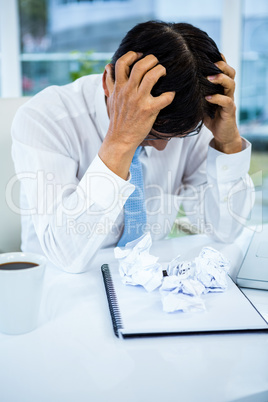 Worried businessman working at his desk