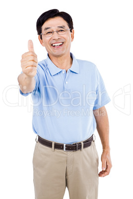 Portrait of happy man showing thumbs up while standing