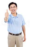 Portrait of happy man showing thumbs up while standing