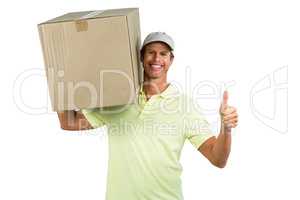 Cheerful delivery man with box showing thumbs up