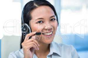 Smiling businesswoman using headset