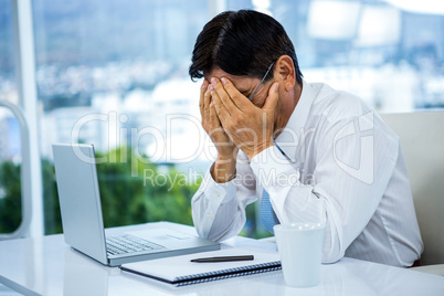 Worried businessman working at his desk