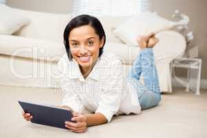 Smiling brunette using tablet