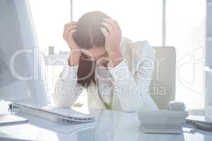 Stressed businesswoman working at her desk