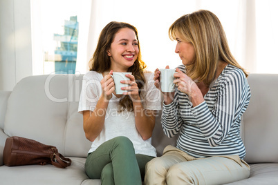 Mother and daughter drinking tea