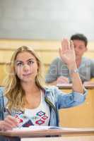 Attractive student raising hand during class