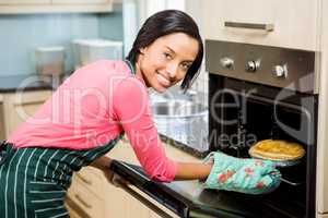 Smiling woman baking pie