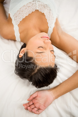 Brunette sleeping on the bed