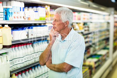 Senior man buying milk