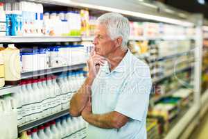 Senior man buying milk