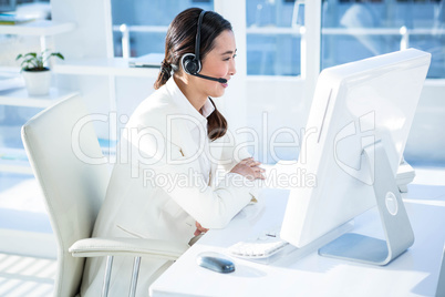 Smiling businesswoman with headset working