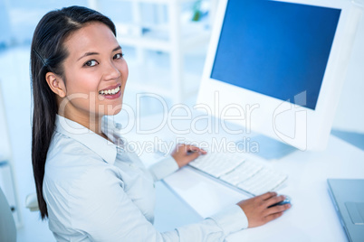 Smiling businesswoman working on computer Smiling businesswoman working on computer