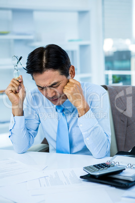 Worried businessman working at his desk