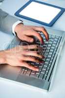 Businessman typing on his laptop