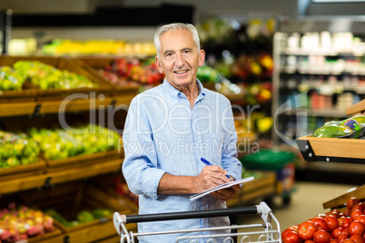 Smiling senior man with grocery list