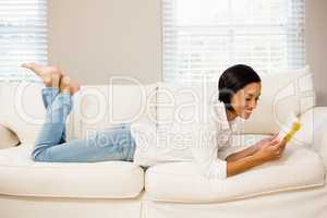 Smiling brunette reading a book