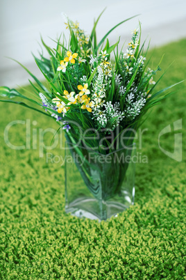 Beautiful field of colorful flowers in a glass vase, a bouquet for March 8, birthday or St. Valentine's day