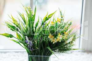 Beautiful field of colorful flowers in a glass vase, a bouquet for March 8, birthday or St. Valentine's day