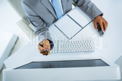Businessman pointing at computer monitor