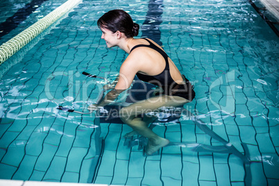 Woman cycling in the pool