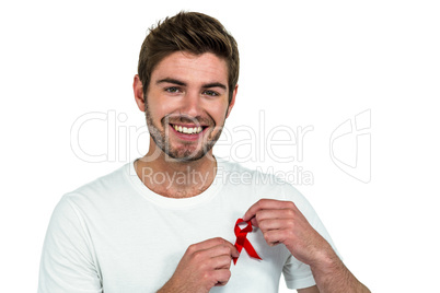Portrait of smiling man with red ribbon