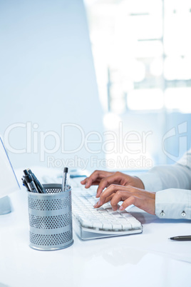 Businesswomans hands typing on computer keyboard