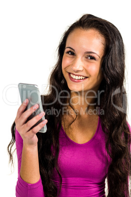 Attractive woman holding smartphone and looking at the camera