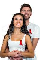 Smiling couple hugging with red ribbons
