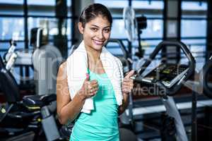 Smiling fit woman with thumbs up