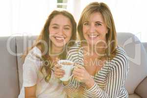 Mother and daughter drink tea