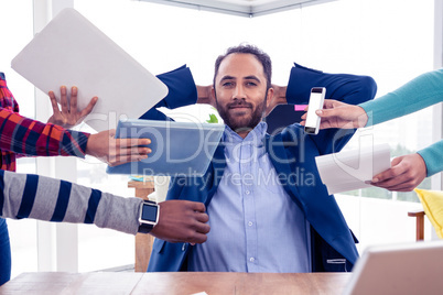 Portrait of smart businessman relaxing in office