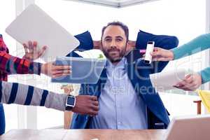 Portrait of smart businessman relaxing in office