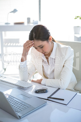 Stressed businesswoman working at her desk