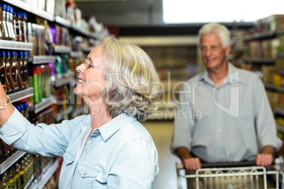 Smiling senior woman choosing food