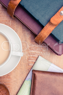 Close-up of coffee with wallet and diaries Close-up of coffee with wallet and diaries
