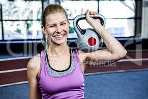 Portrait of woman holding kettlebell