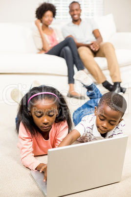 Happy kids using laptop pc