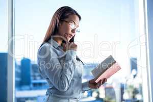 Concentrated businesswoman reading book