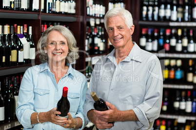 Smiling senior couple choosing wine