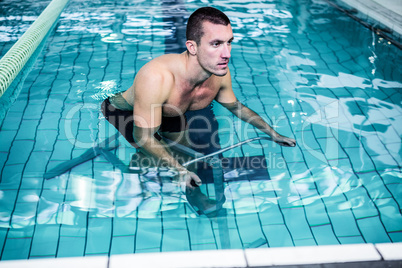 Fit man cycling in the pool