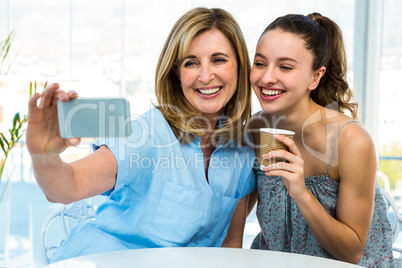 mother and daughter take selfie